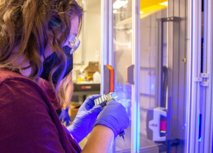 A student works on manufacturing research in a lab.