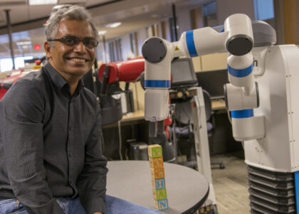 Subbarao Kambhampati poses with a robot