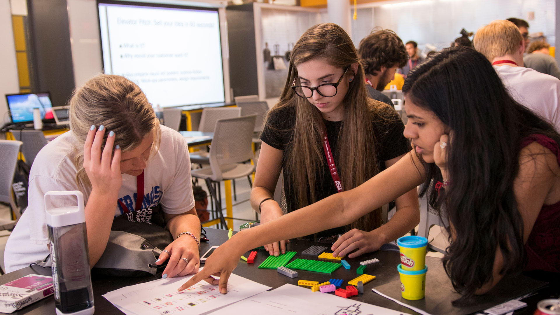 A group of students working together to solve a problem in a classroom.