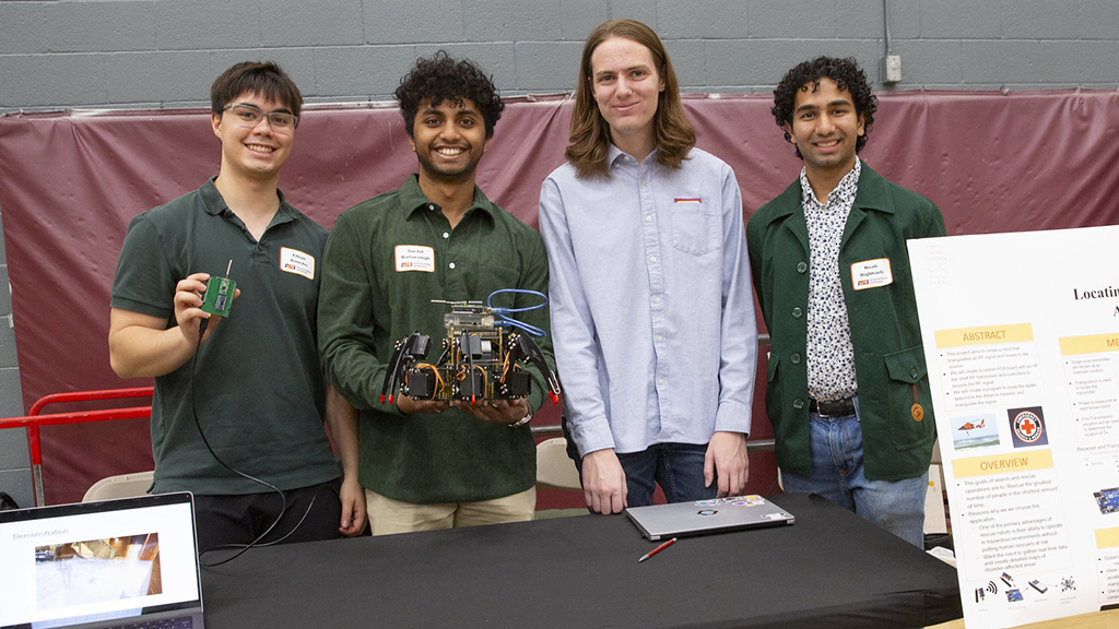 students at table presenting capstone project