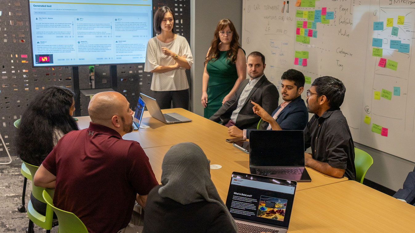 faculty members discussing around a table